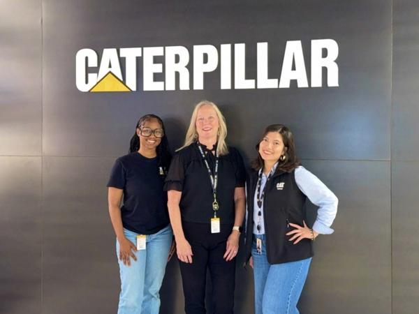 a group of women standing in front of a sign