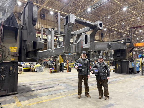 two men standing in a factory