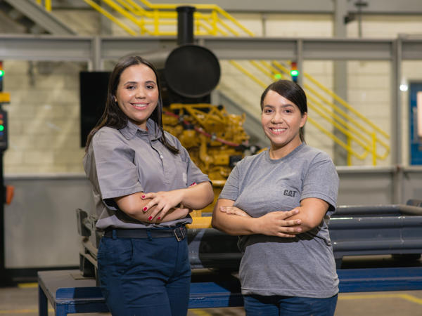 two women standing in a factory