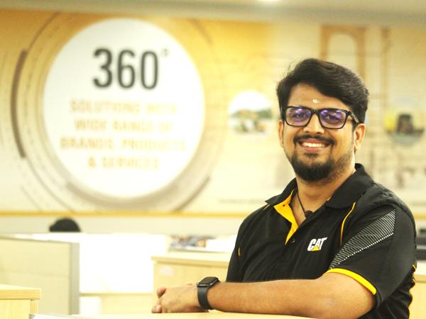 a person wearing glasses and smiling