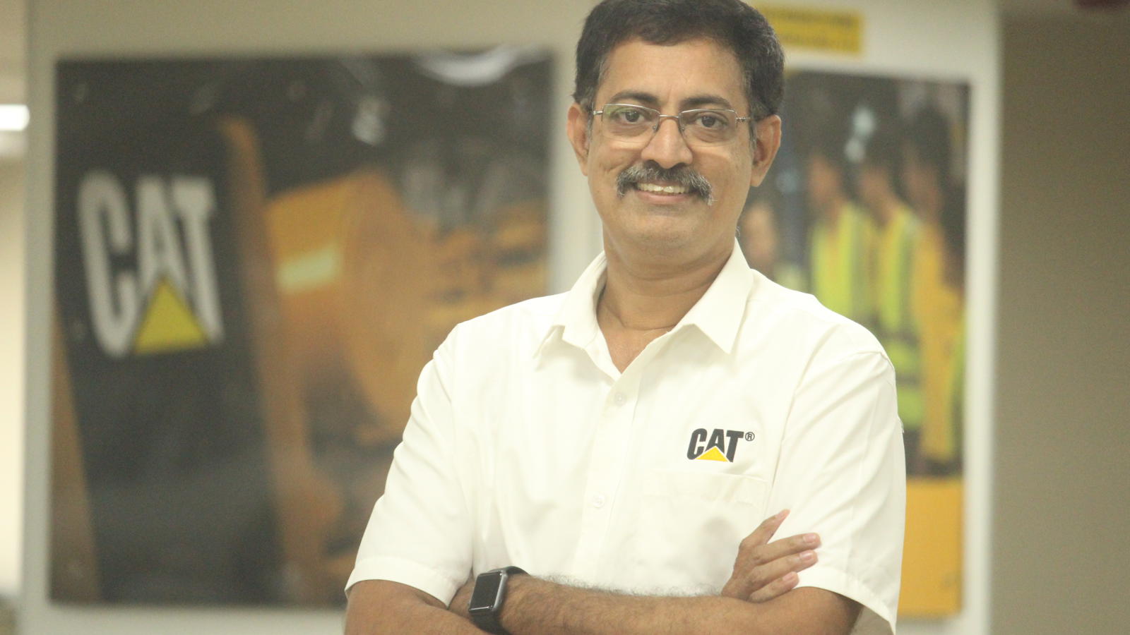 a person with glasses and mustache wearing a white shirt