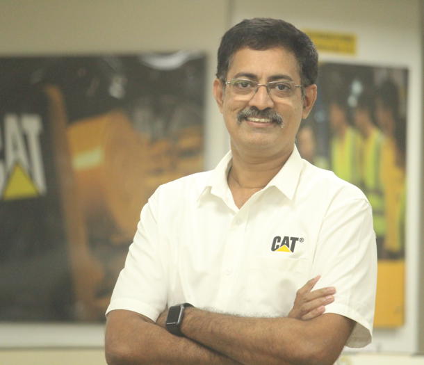 a person with glasses and mustache wearing a white shirt