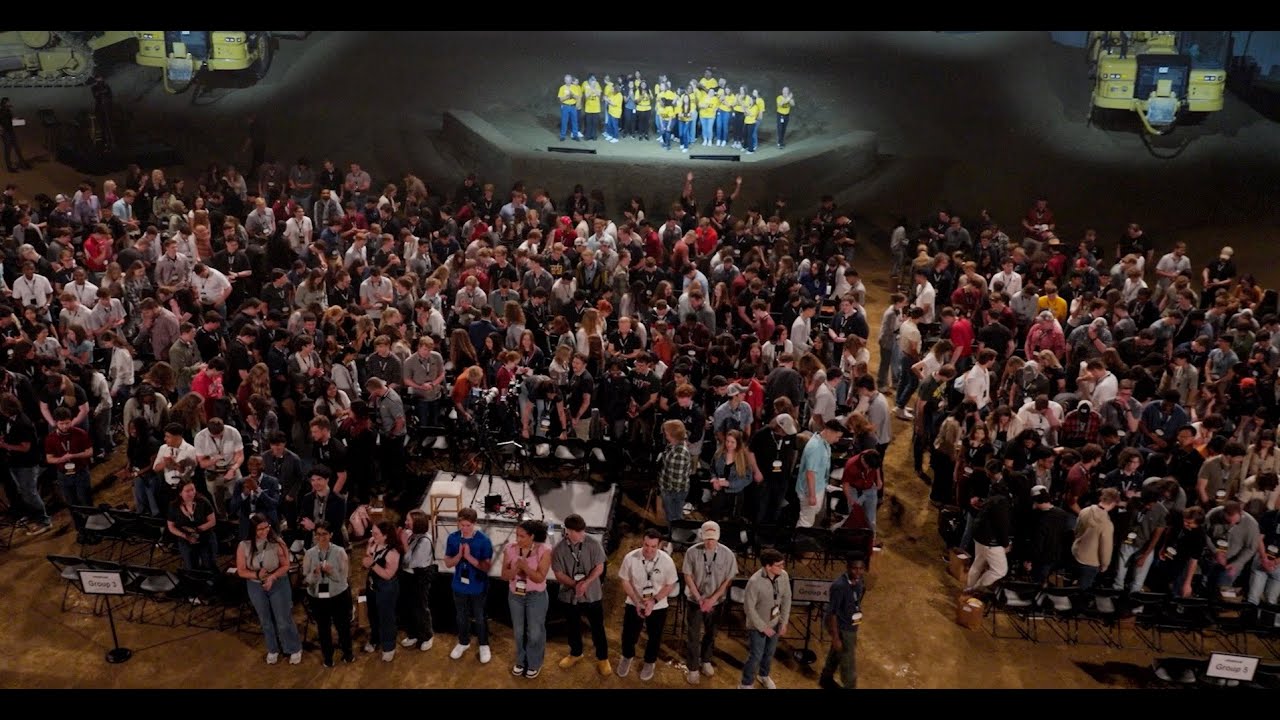 a group of people standing in a large room
