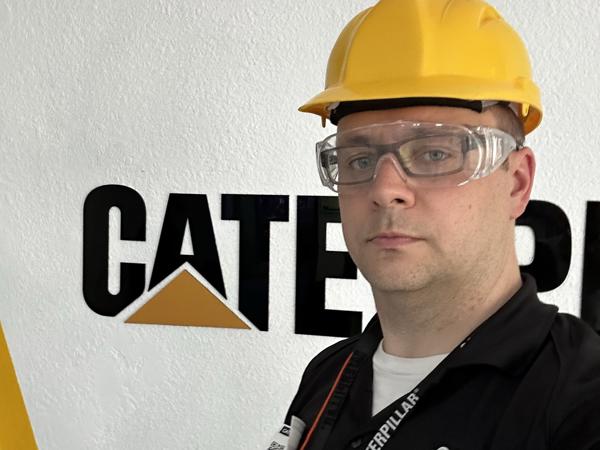 a person wearing a hard hat and glasses