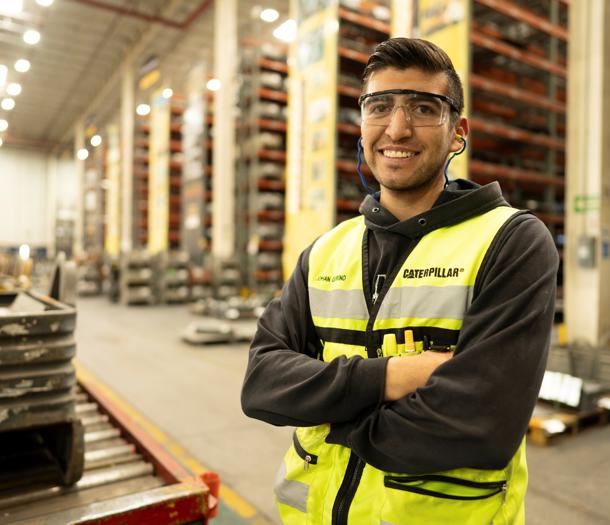 a person wearing safety goggles and a yellow vest