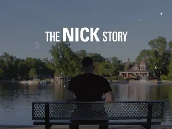a person sitting on a bench looking at a body of water