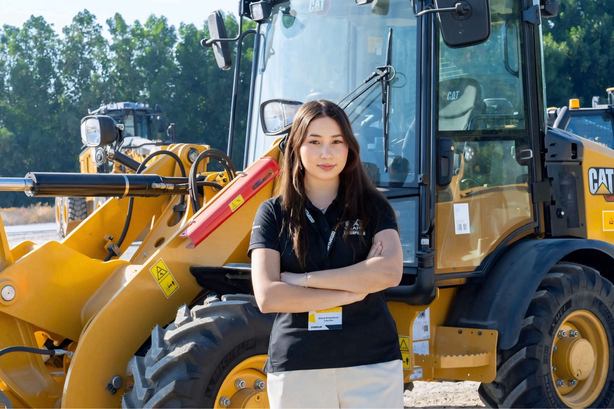 a person standing in front of a construction vehicle