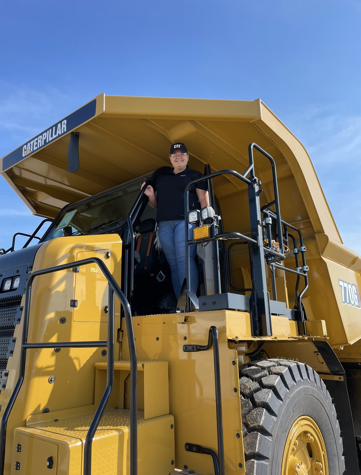 a person standing in the back of a yellow truck