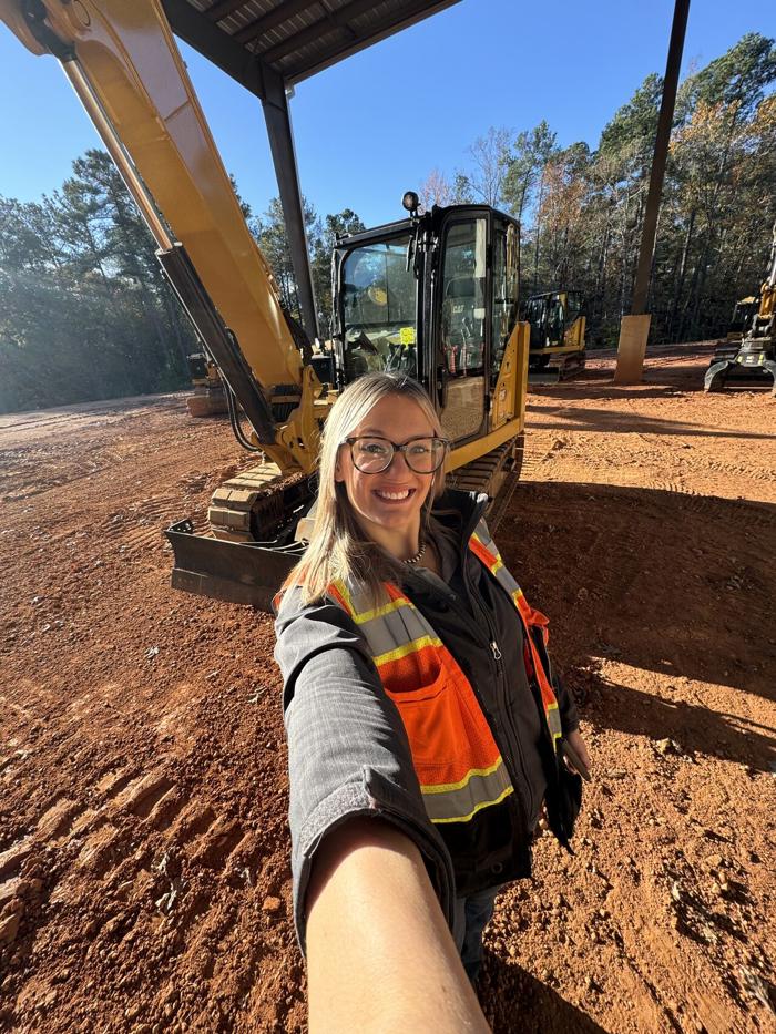 a person taking a selfie with a construction vehicle